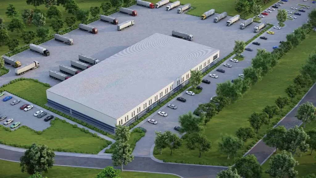 An aerial view of a large building with trucks parked in front of it.