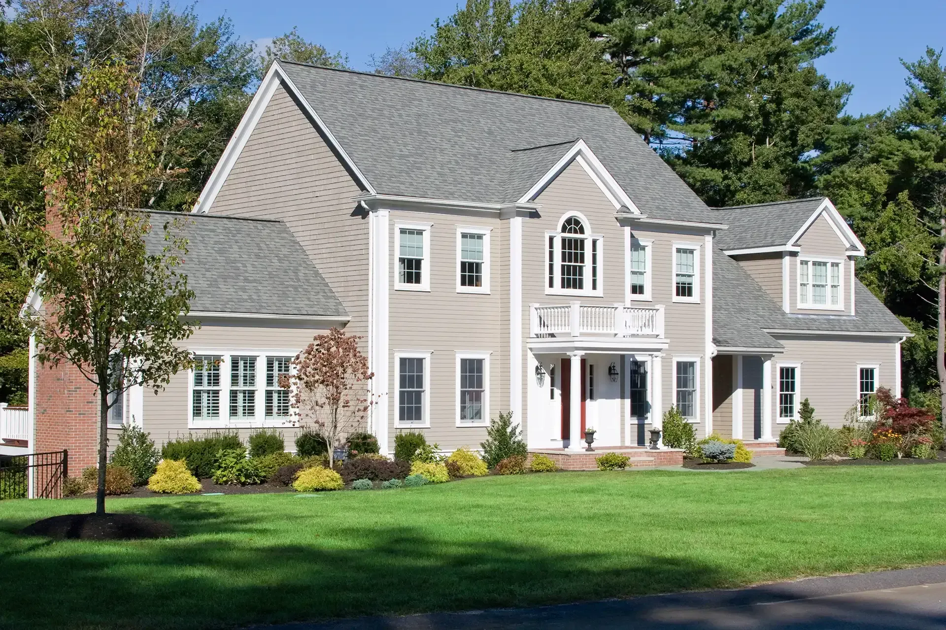 A large house with a lush green lawn in front of it