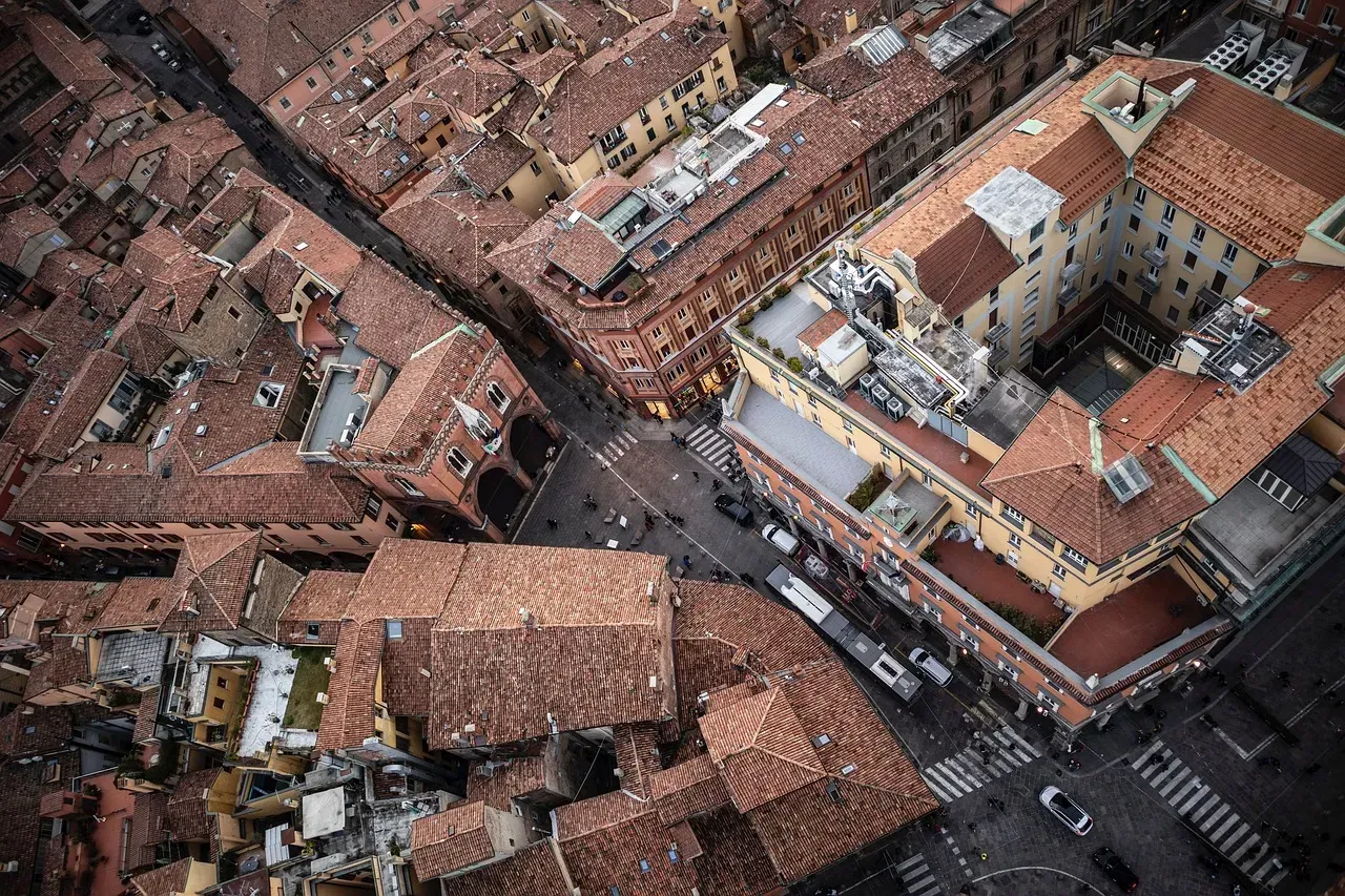 An aerial view of a city with lots of buildings and roofs.