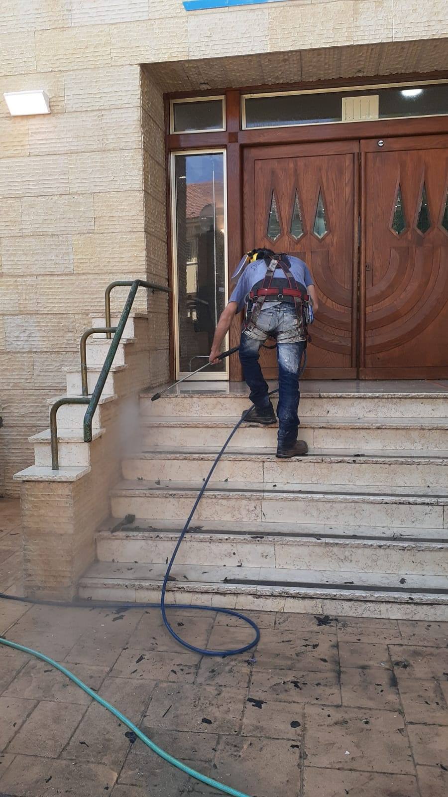 cleaning outside staircase using power wash