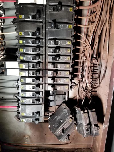 Man fixing fuse box —Electric Panel Installation in York, PA