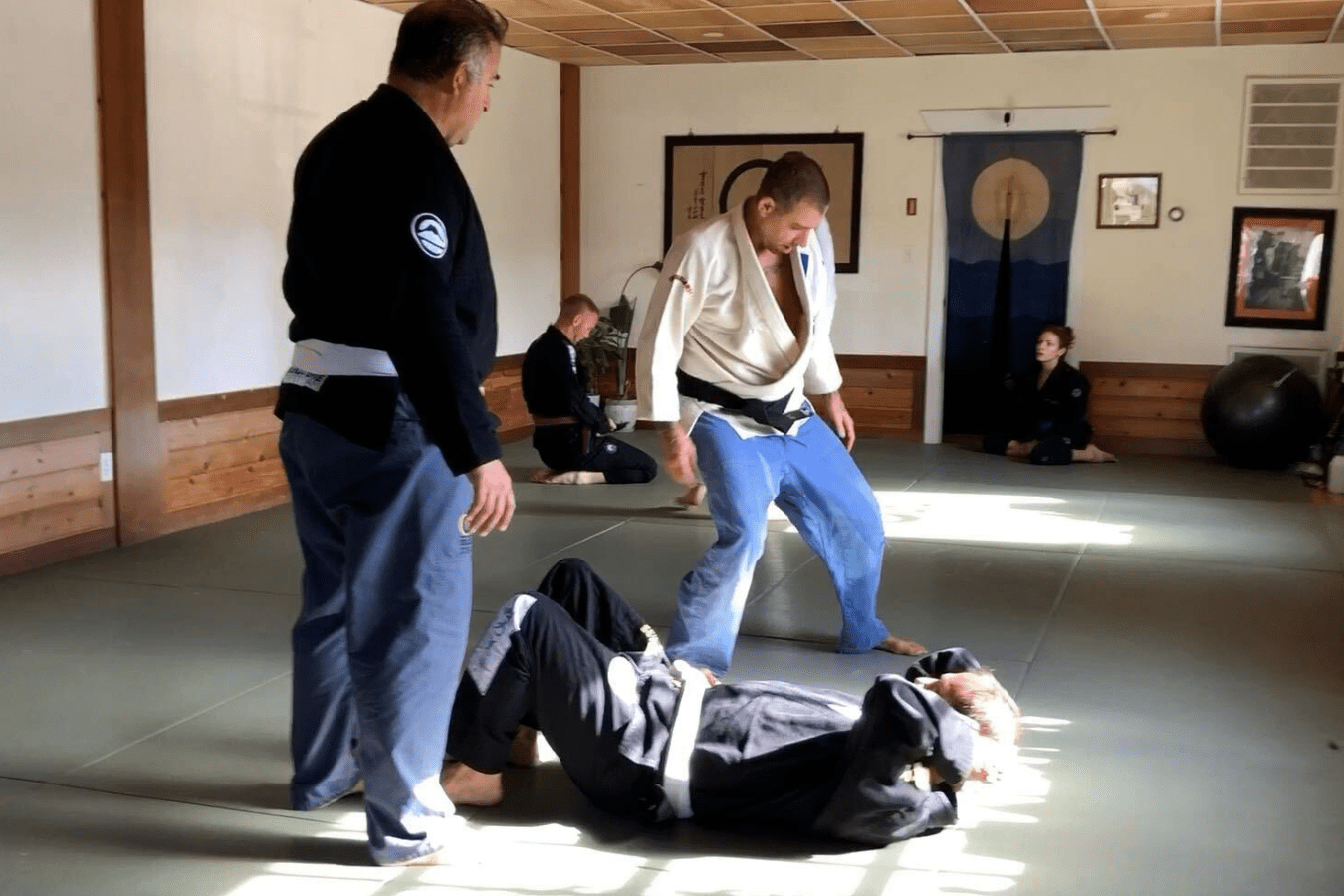 Adults practicing Brazilian Jiu-Jitsu drills at OM Brazilian Jiu-Jitsu & Judo in Northport, NY.