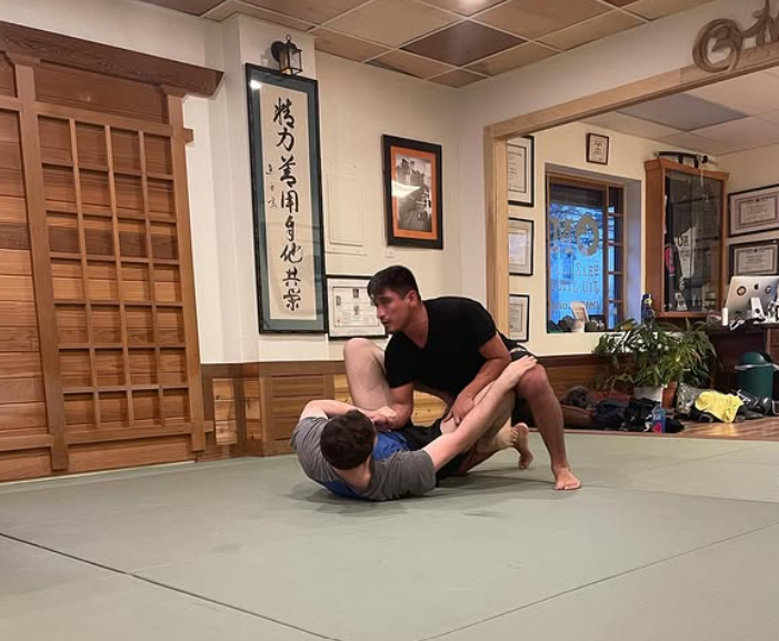 Adults drilling Brazilian Jiu-Jitsu technique at OM Brazilian Jiu JItsu & Judo in Northport, NY for energy and focus.