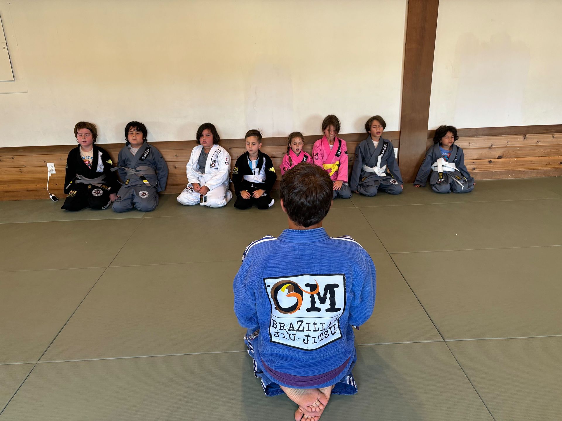 Students practice Brazilian Jiu-Jitsu drills at OM Brazilian Jiu JItsu & Judo in Northport, NY for calm confidence.
