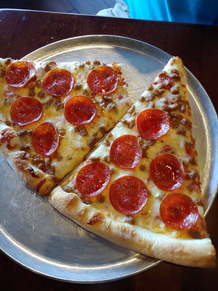 two slices of pepperoni pizza on a pizza pan