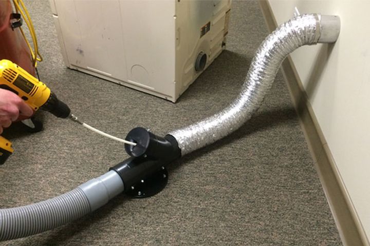a person is fixing an air conditioner with a screwdriver .