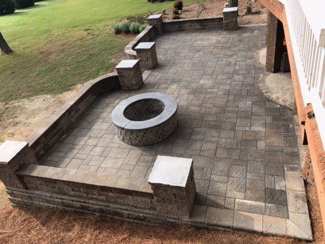 There is a fire pit in the middle of the patio.