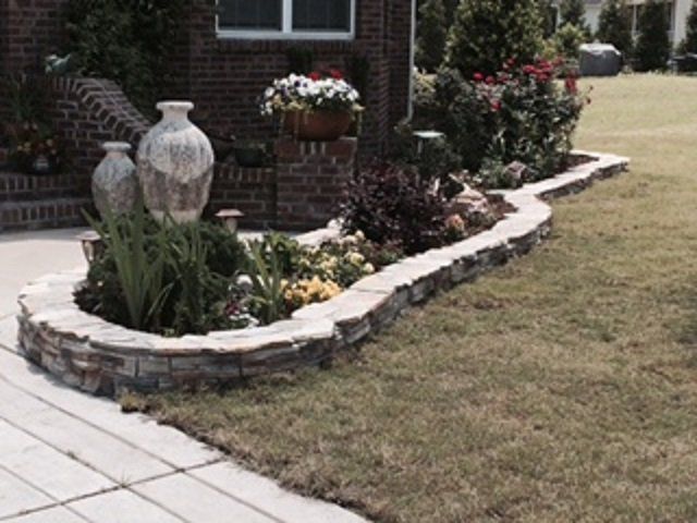 A brick house with a garden in front of it