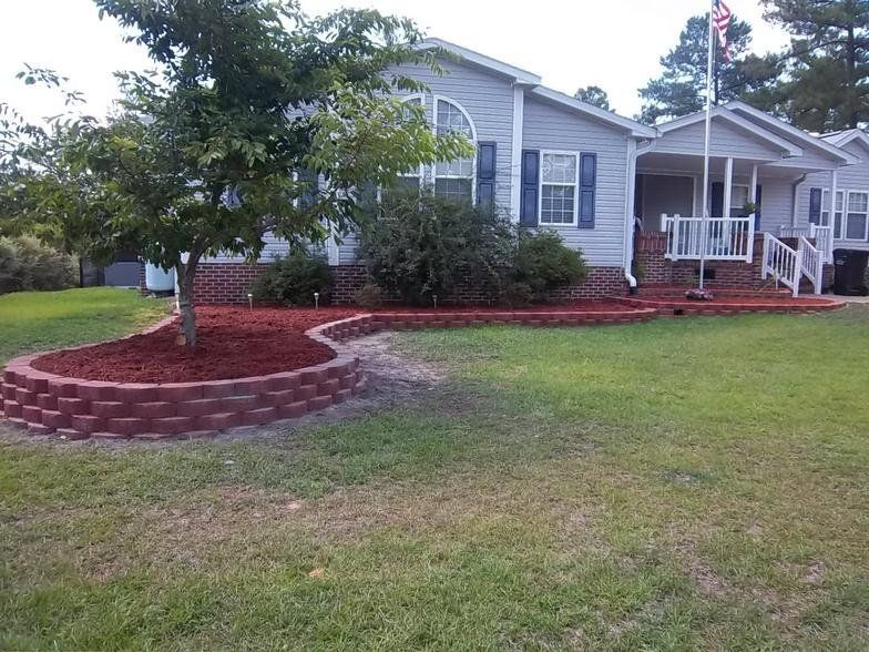 A mobile home with a flag in front of it
