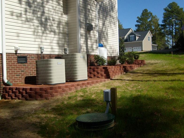 A house with two air conditioners on the side of it