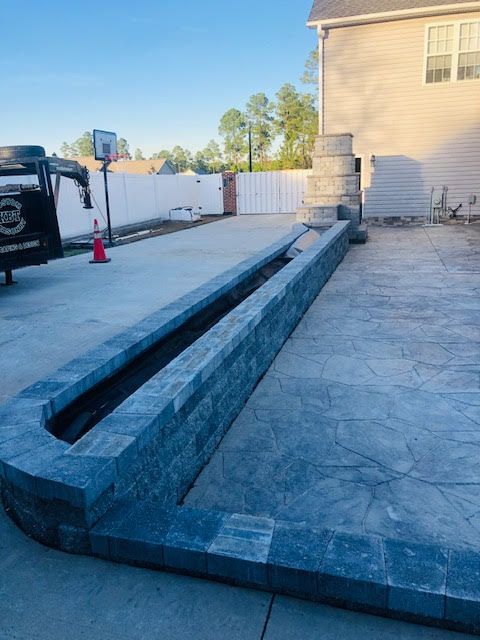 A basketball hoop is being built in the backyard of a house
