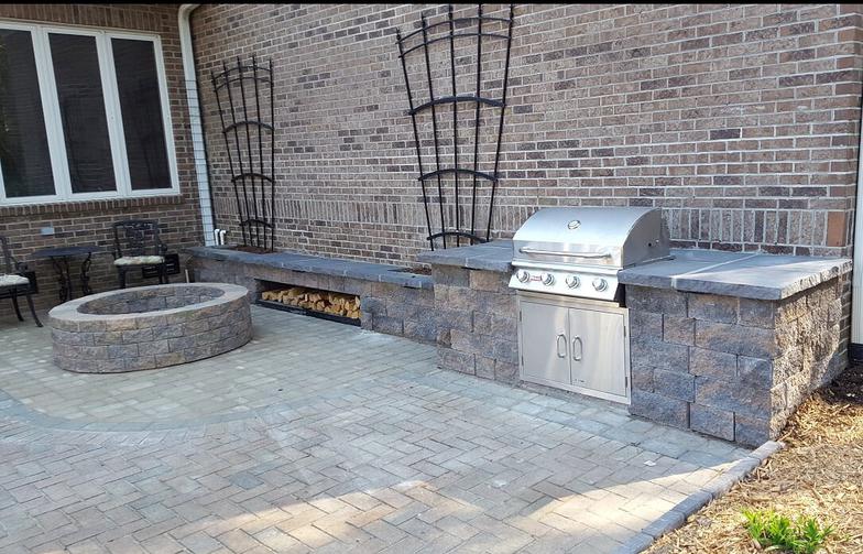 There is a grill and a fire pit in the backyard.