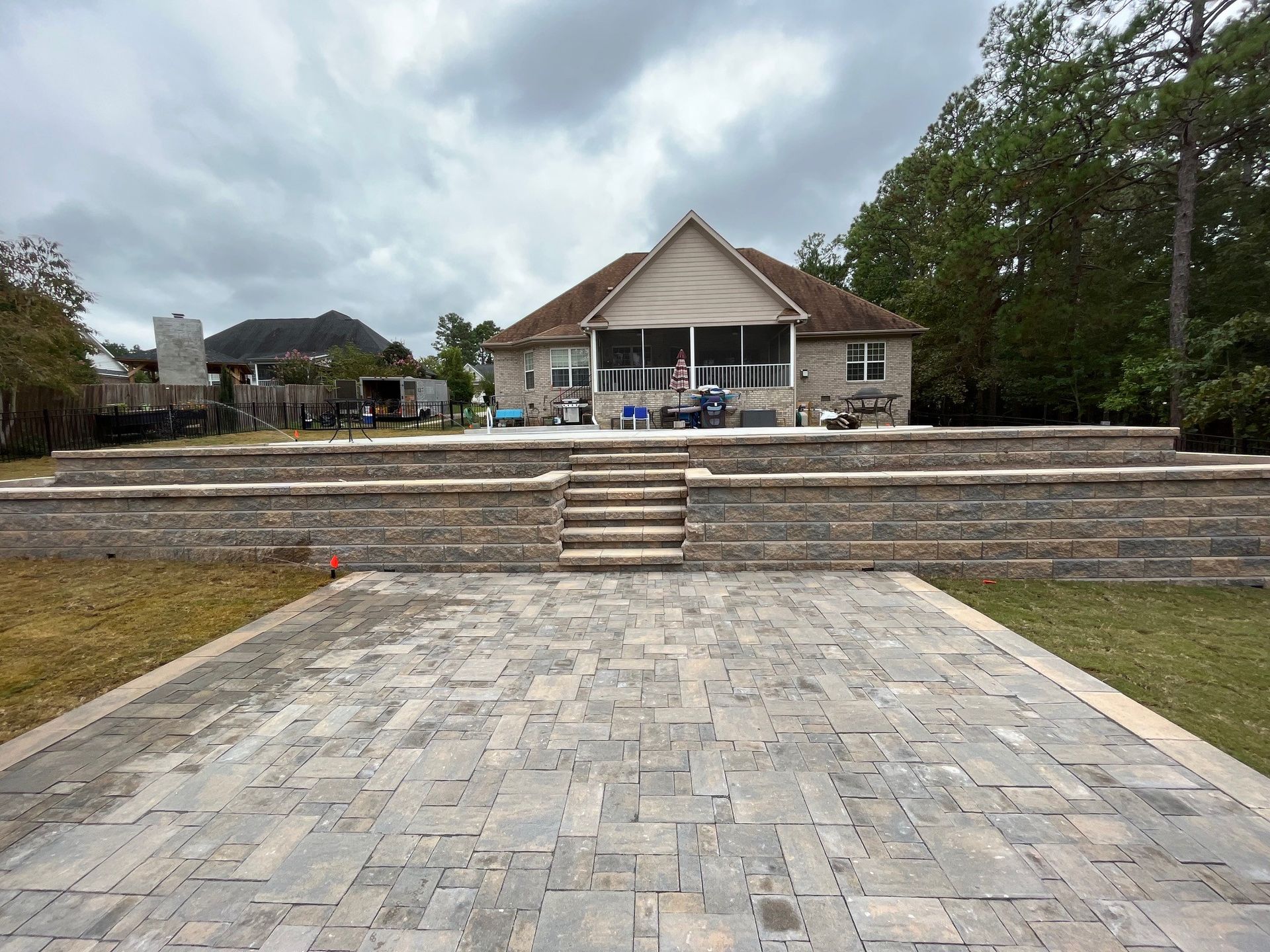 A large house with a patio and stairs in front of it.