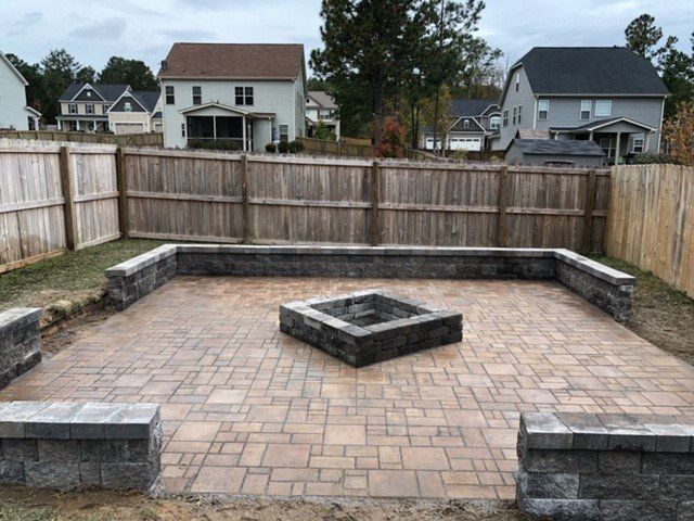 There is a fire pit in the middle of the patio.