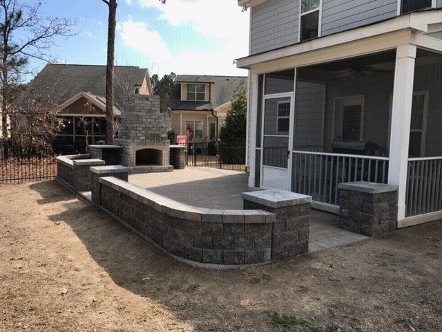 A house with a screened in porch and a fireplace