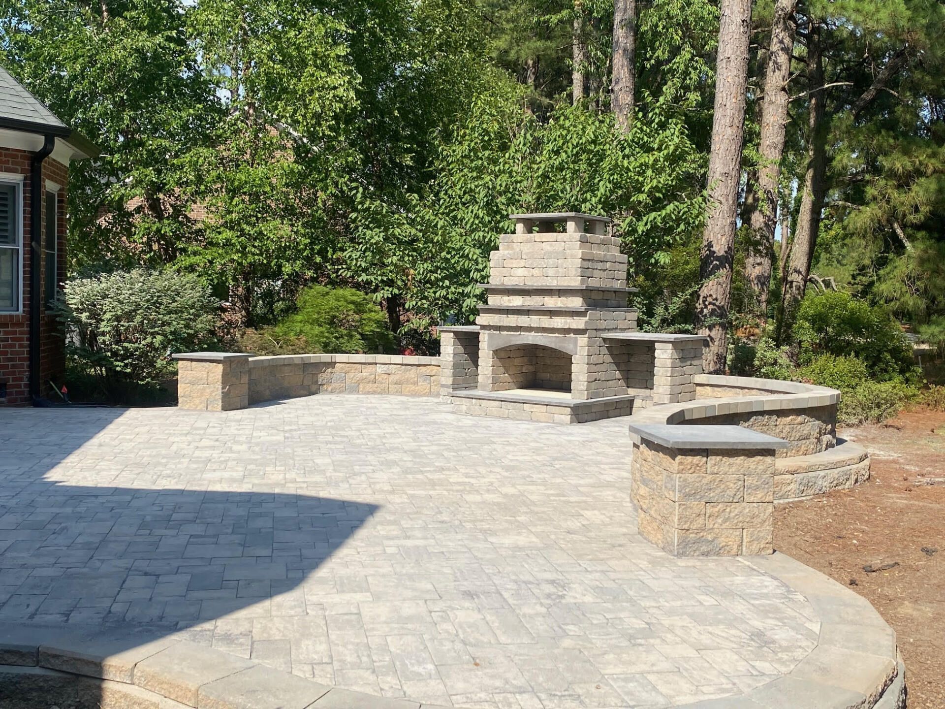 A patio with a fireplace in the middle of it