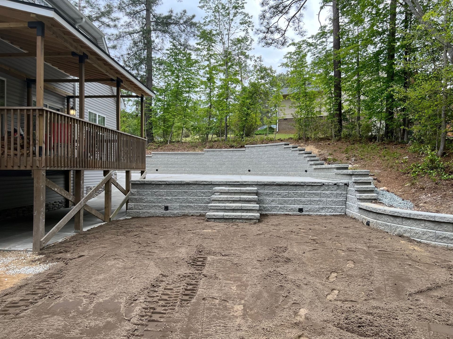 A house with a deck and stairs in the backyard.