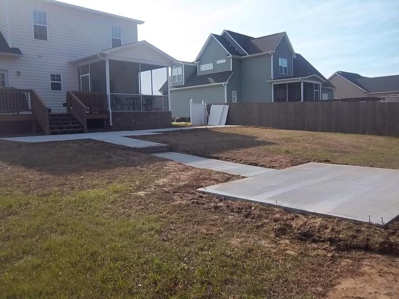 A house with a concrete walkway in front of it