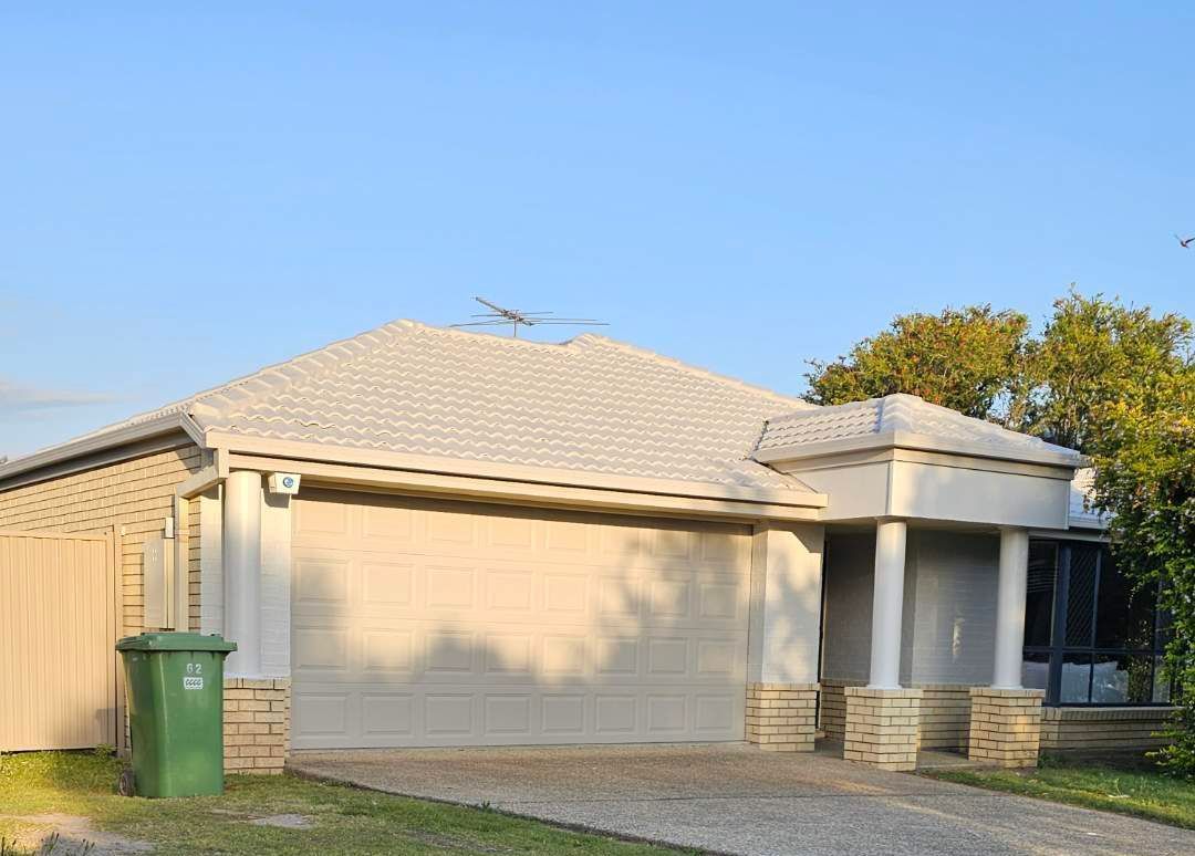 A wooden deck with a table and chairs next to a pool — Solo Reno Coatings In Gold Coast, QLD