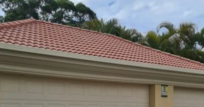 A house with a red tiled roof and a white garage door — Solo Reno Coatings In Gold Coast, QLD