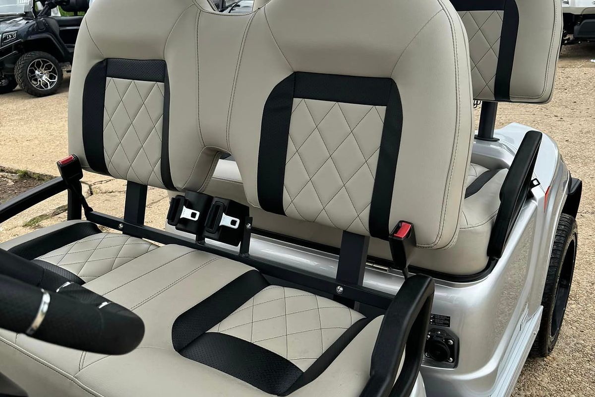 The back seat of a golf cart is shown.