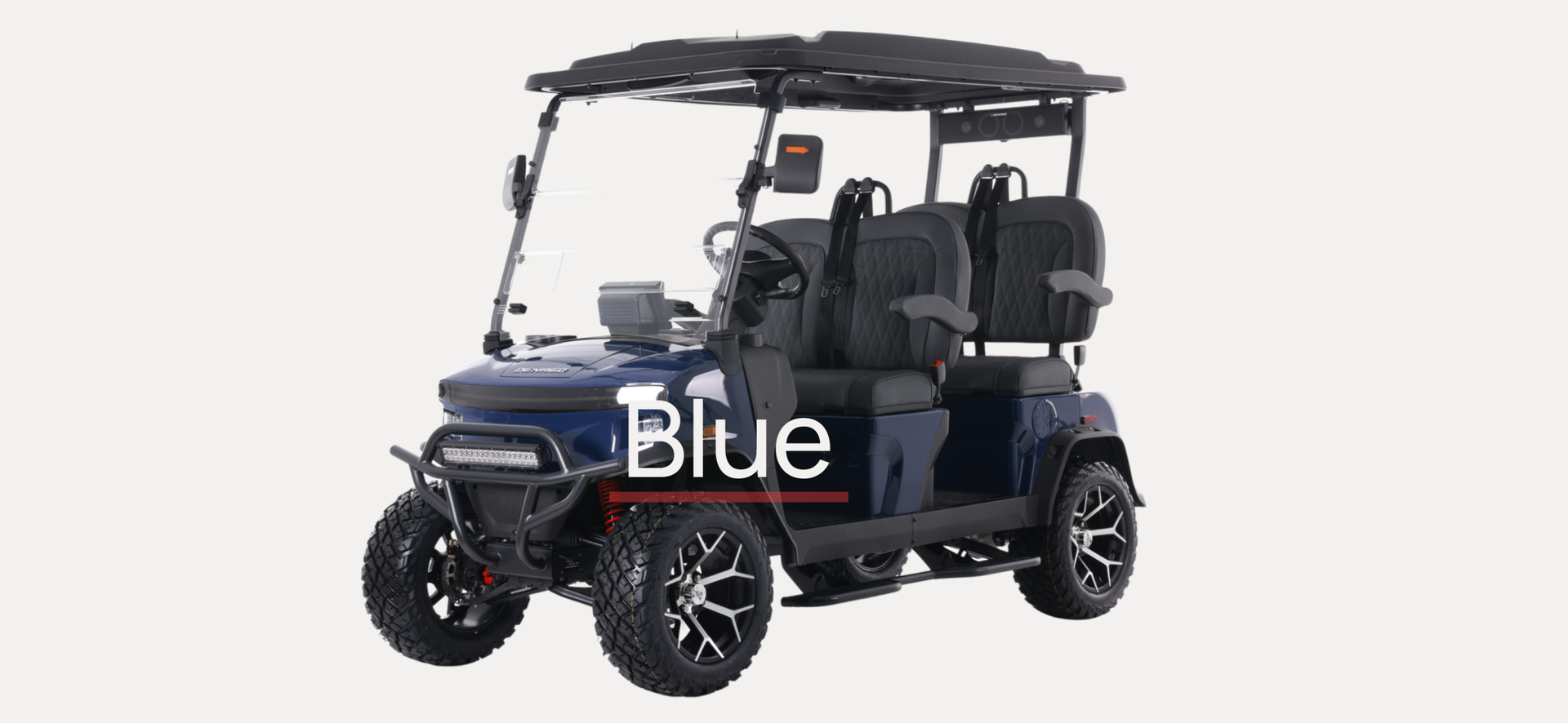 A white golf cart is parked on the side of the road in front of a building.