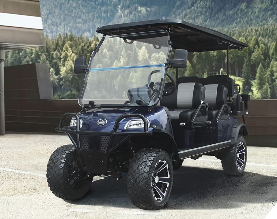 A blue golf cart is parked in a parking lot.