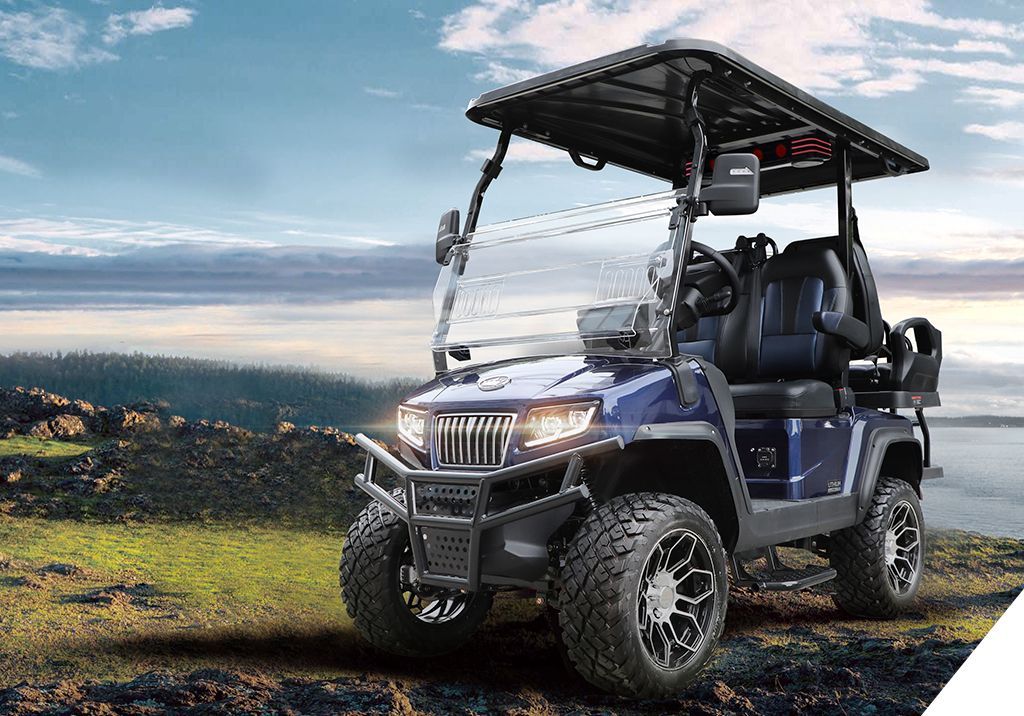 A blue golf cart with a canopy is parked on the side of the road.