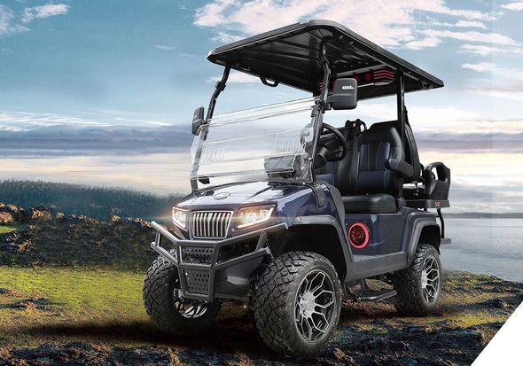 A golf cart with a canopy is parked on the side of a road.