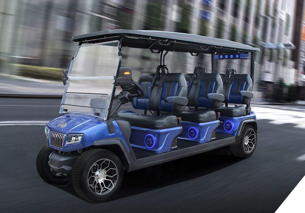 A blue golf cart is driving down a city street.