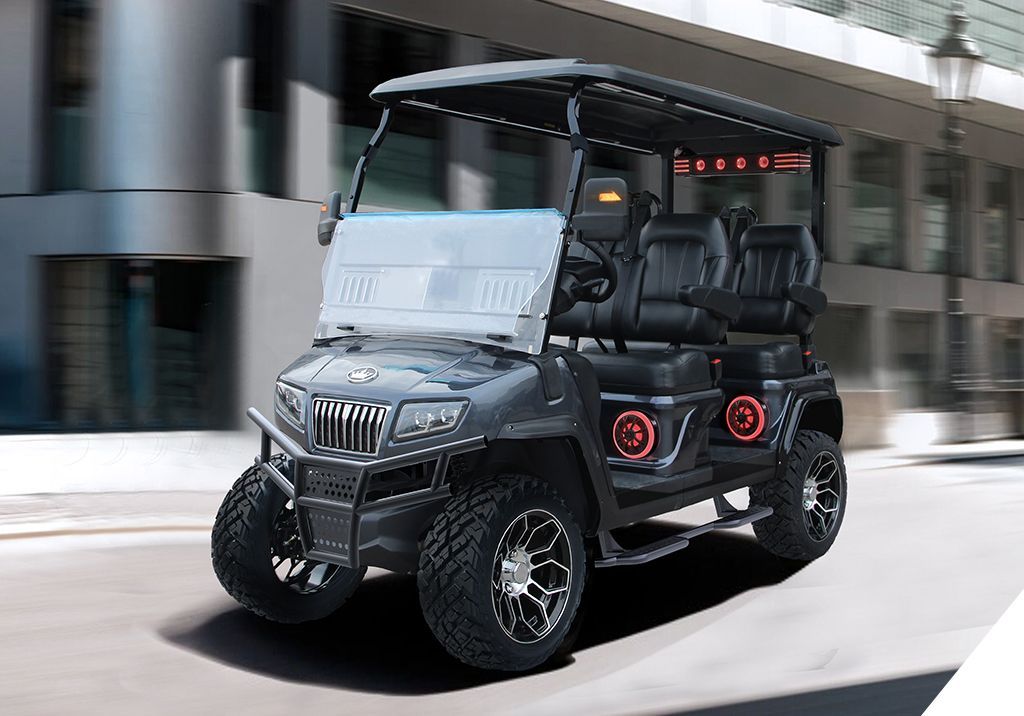A black golf cart is driving down a city street.