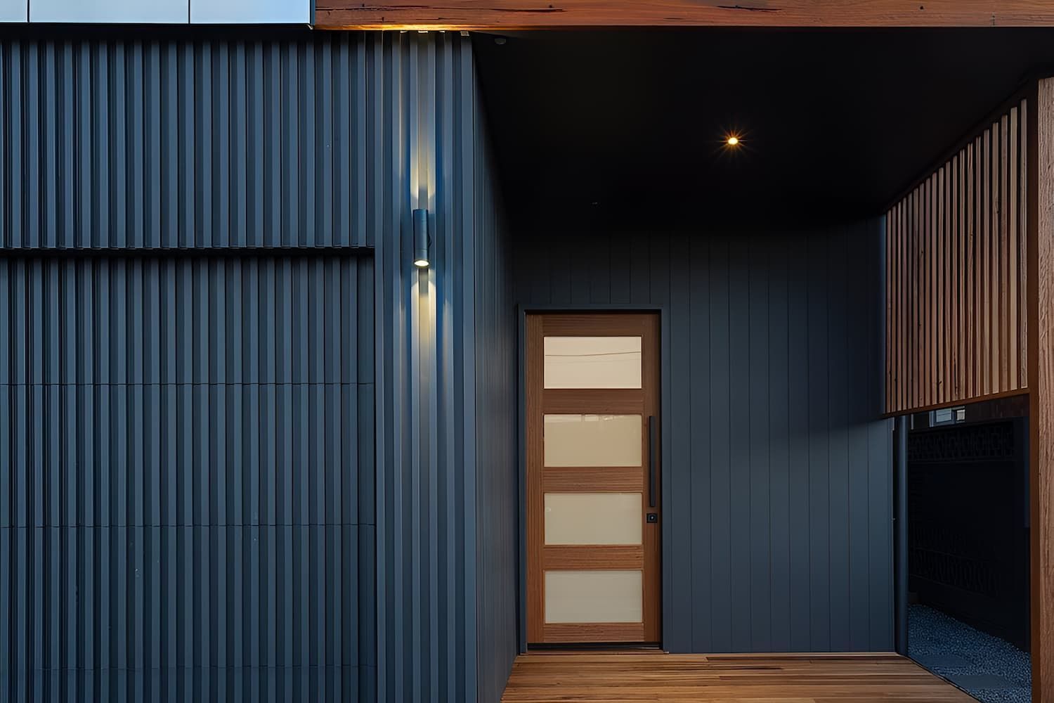 A Blue House With A Wooden Porch And A Wooden Door — DeBu Studios In Kiama, NSW