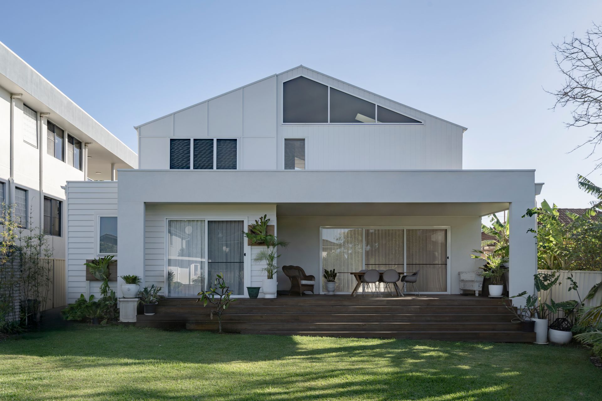 The back of a white house with a large lawn in front of it — DeBu Studios In Southern Sydney, NSW