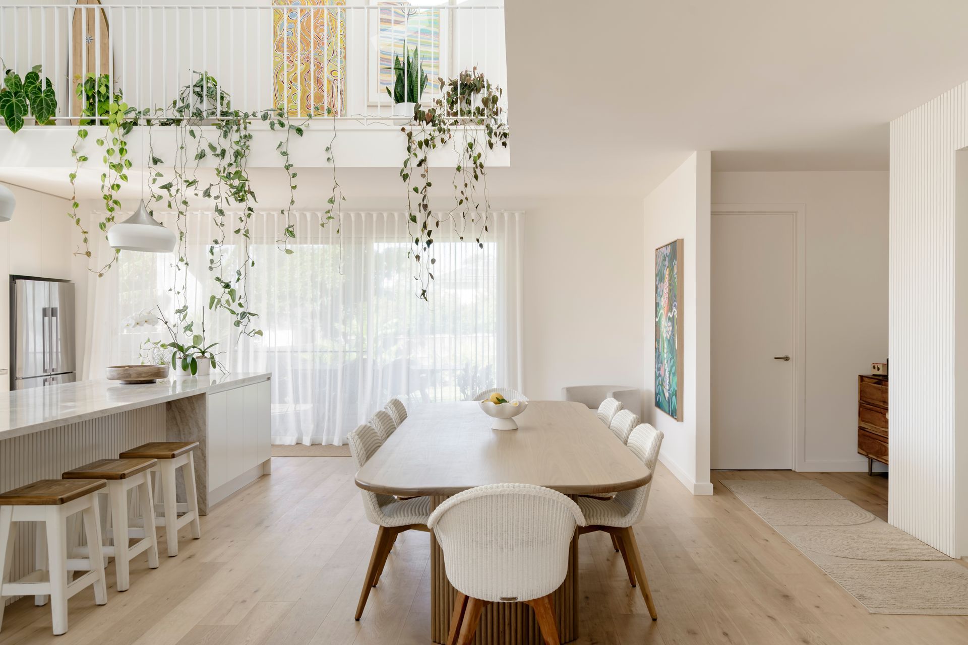 There is a dining table and chairs in the middle of the room — DeBu Studios In Southern Sydney, NSW