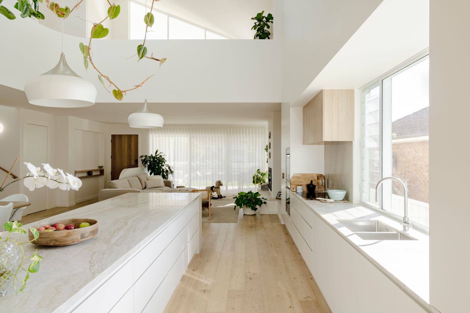 A kitchen with a sink and a bowl of fruit on the counter — DeBu Studios In Southern Sydney, NSW
