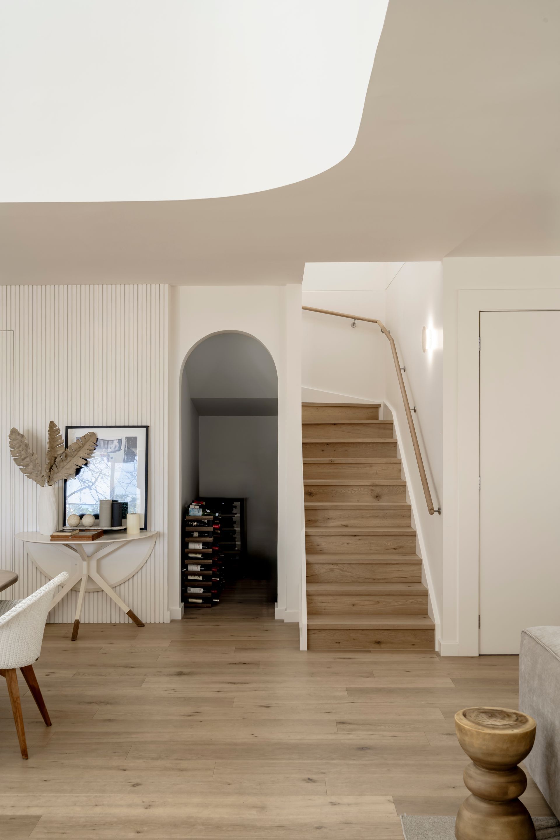 A living room with wooden floors and stairs leading up to the second floor — DeBu Studios In Southern Sydney, NSW