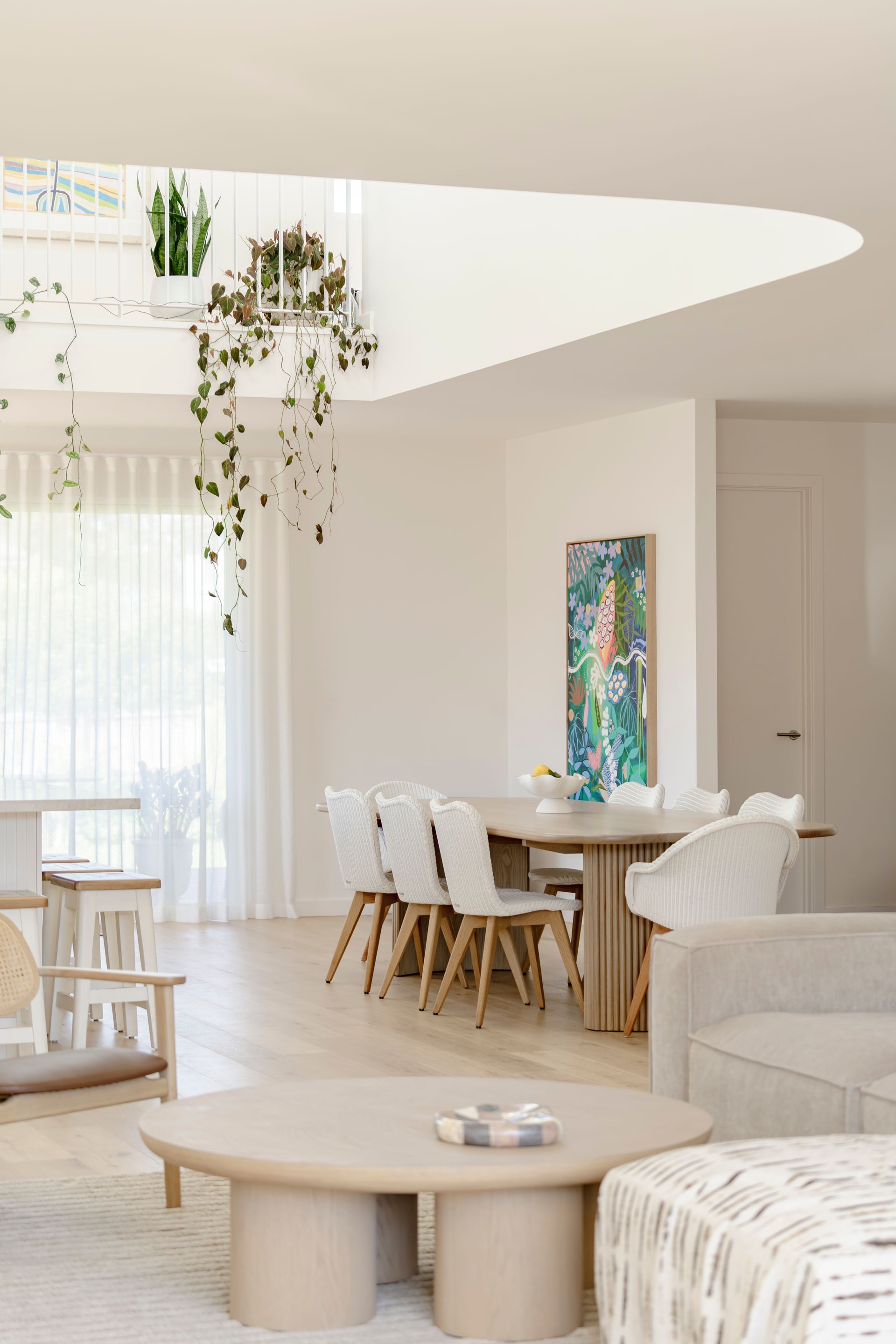 A living room with a table and chairs and a dining room with a table and chairs — DeBu Studios In Southern Sydney, NSW