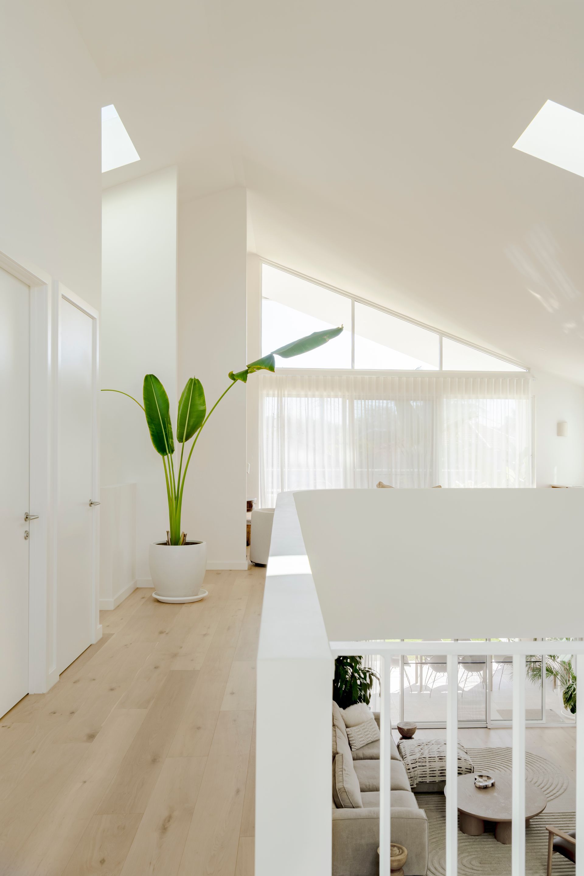 A view of a living room from the second floor of a house — DeBu Studios In Southern Sydney, NSW