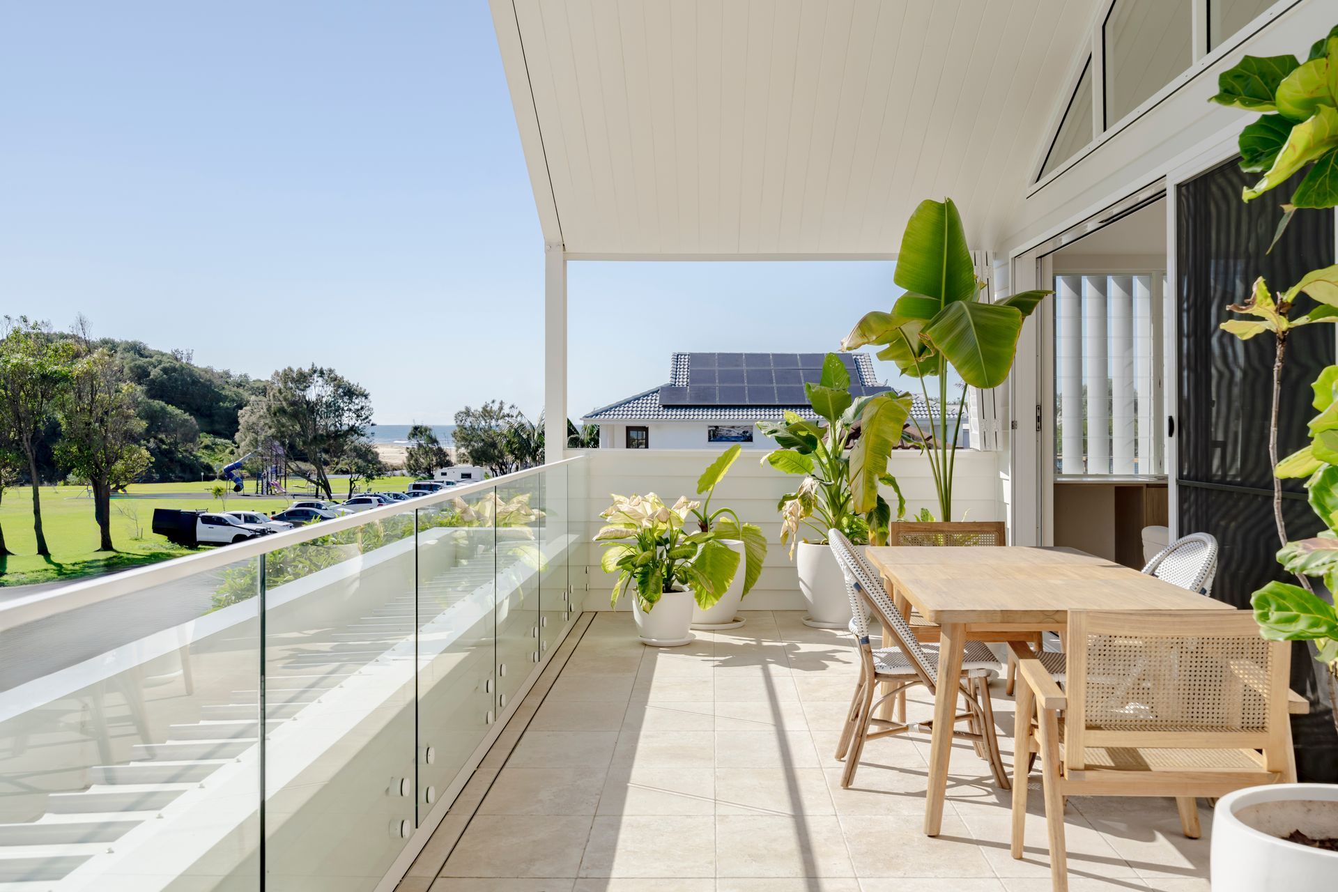 There is a large balcony with a table and chairs on it — DeBu Studios In Southern Sydney, NSW