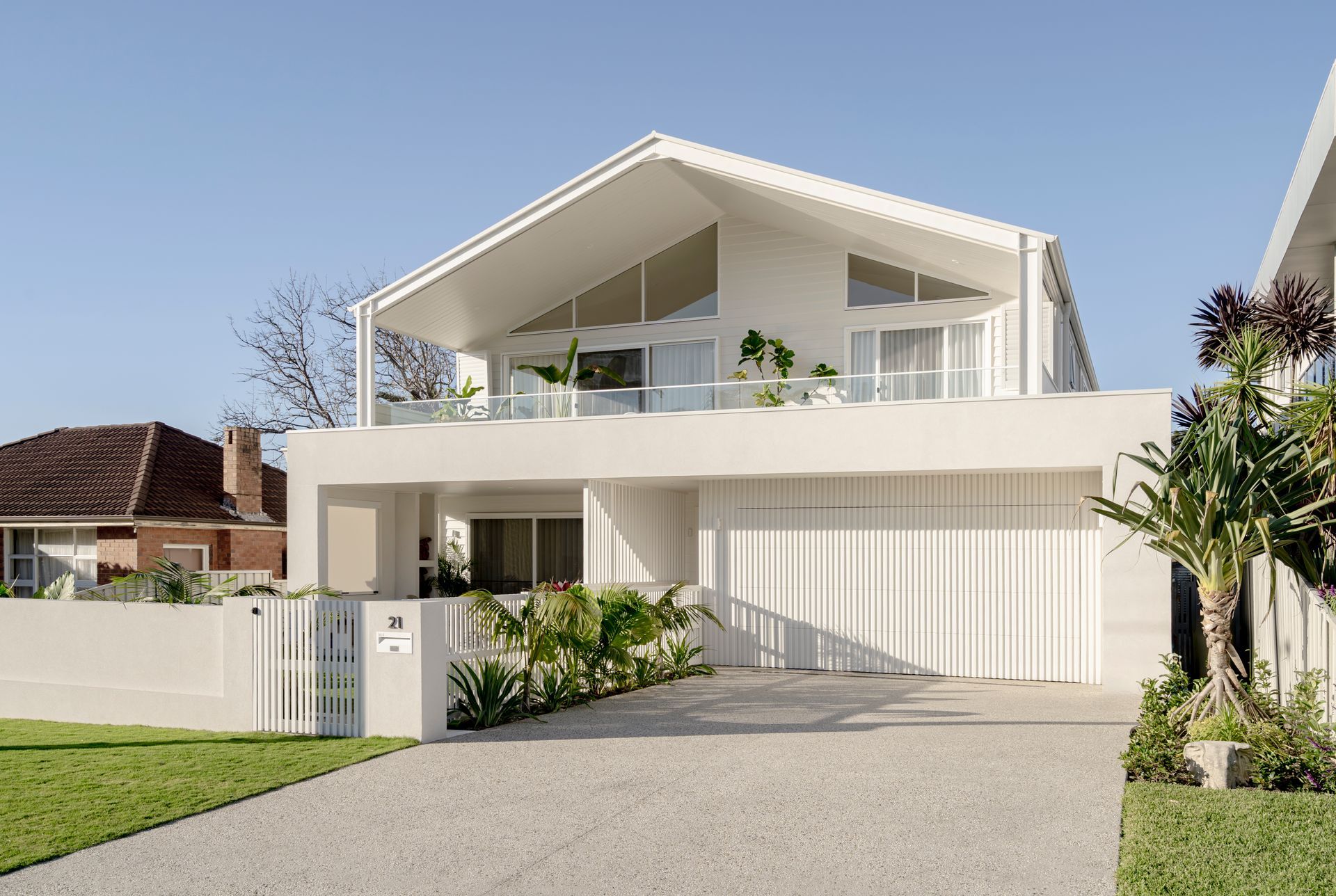 A large white house with a driveway leading to it — DeBu Studios In Southern Sydney, NSW