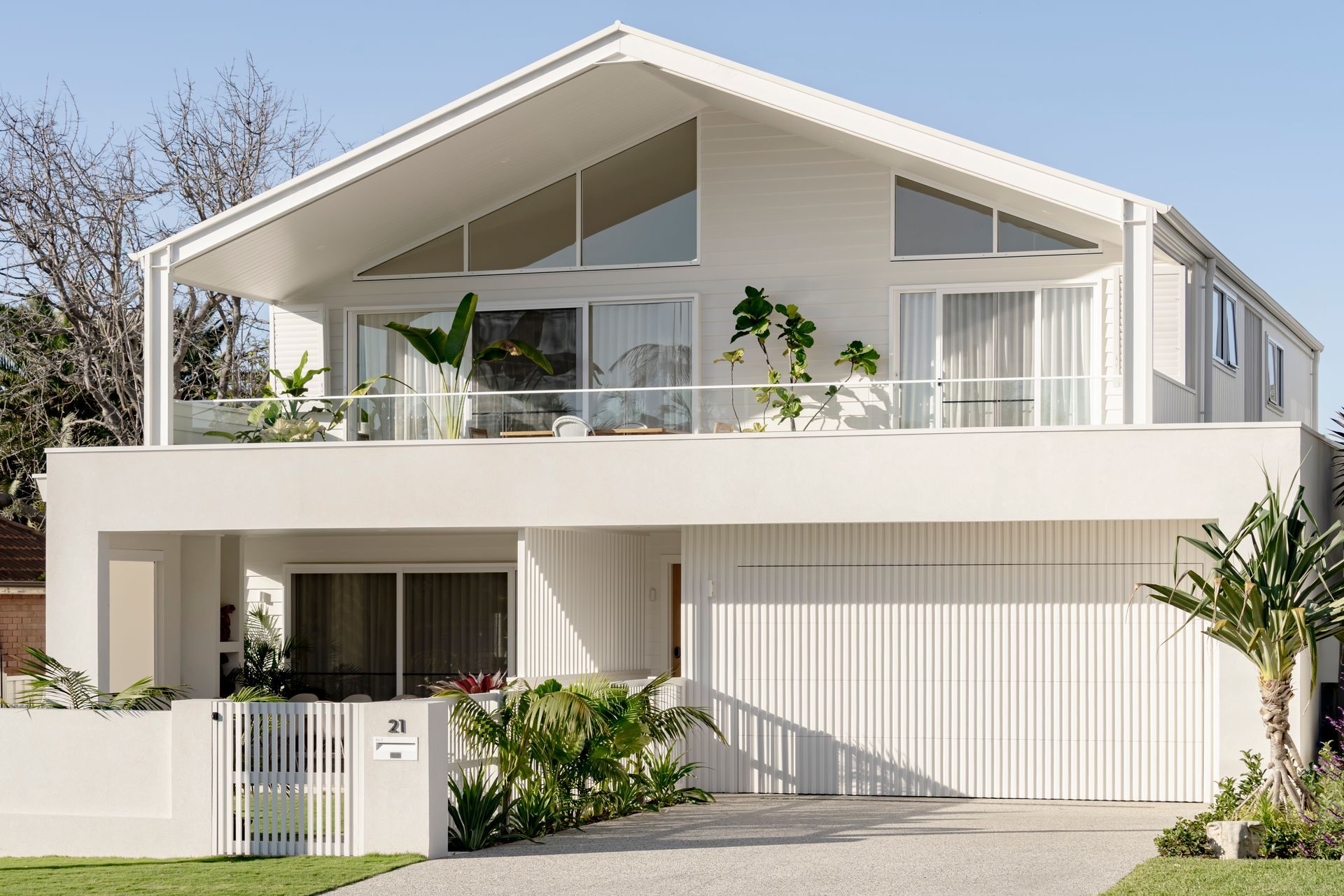 A large white house with a balcony and a garage — DeBu Studios In Southern Sydney, NSW