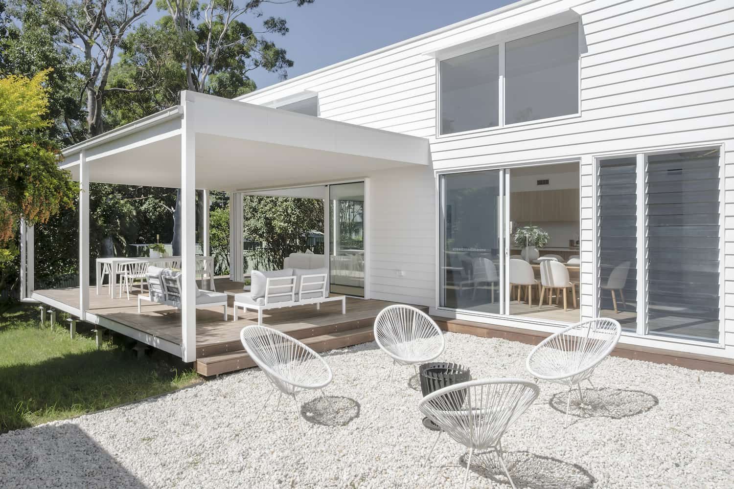 A White House With A Patio And Chairs In Front Of It — DeBu Studios In Russell Vale, NSW