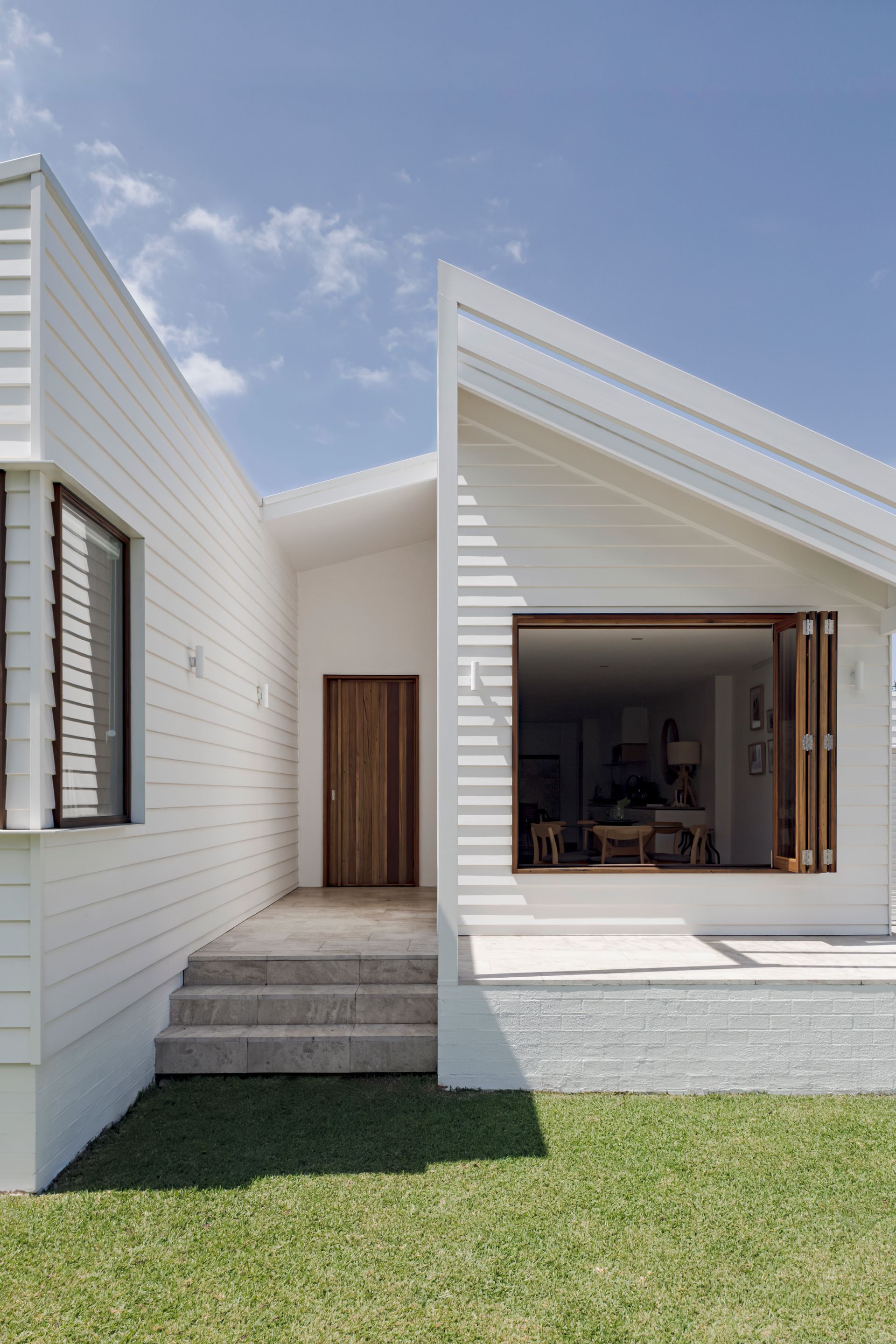 A white house with a vaulted roof — DeBu Studios In Southern Sydney, NSW