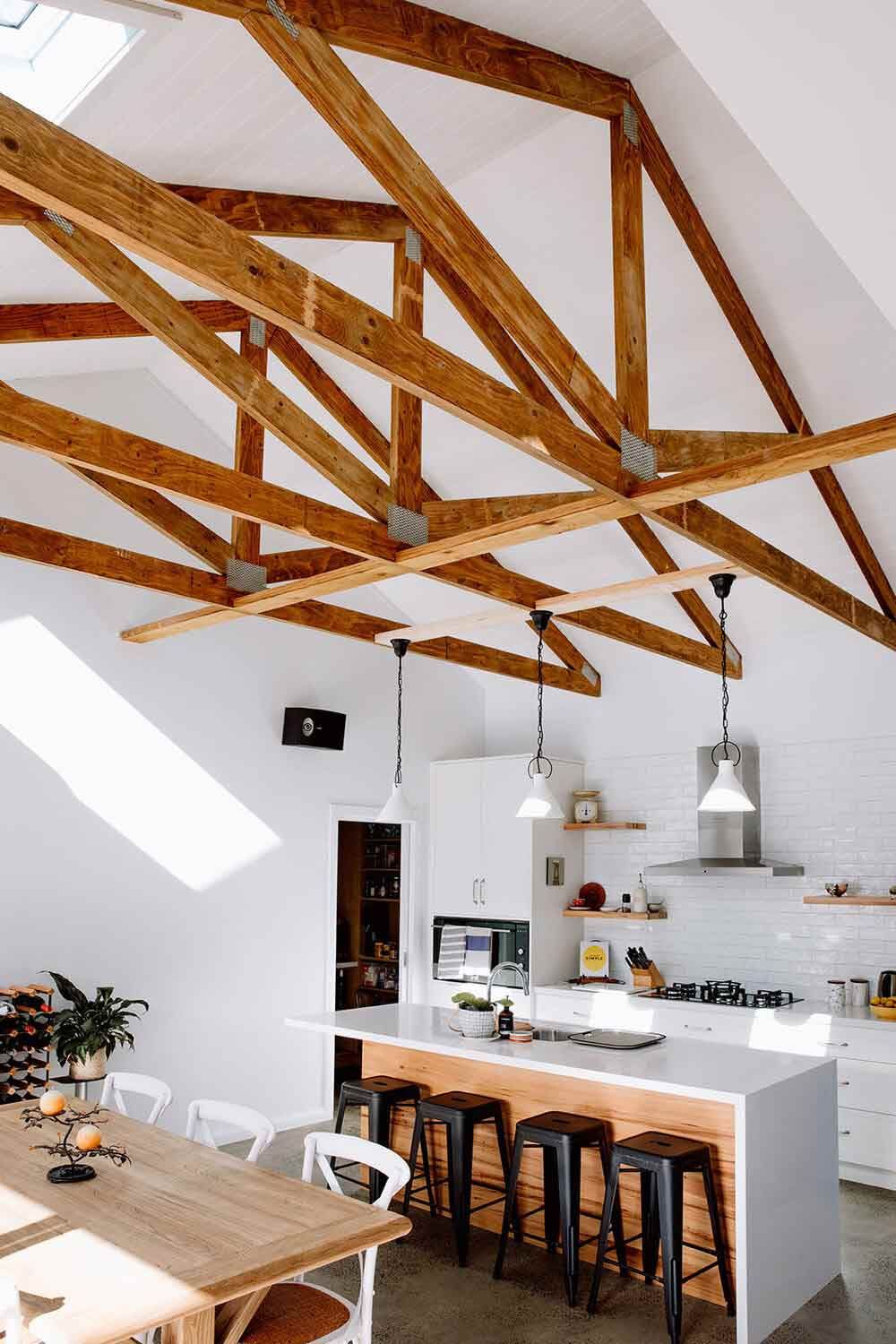 A Kitchen With a Wooden Ceiling and a Table and Chairs — DeBu Studios In Russell Vale, NSW