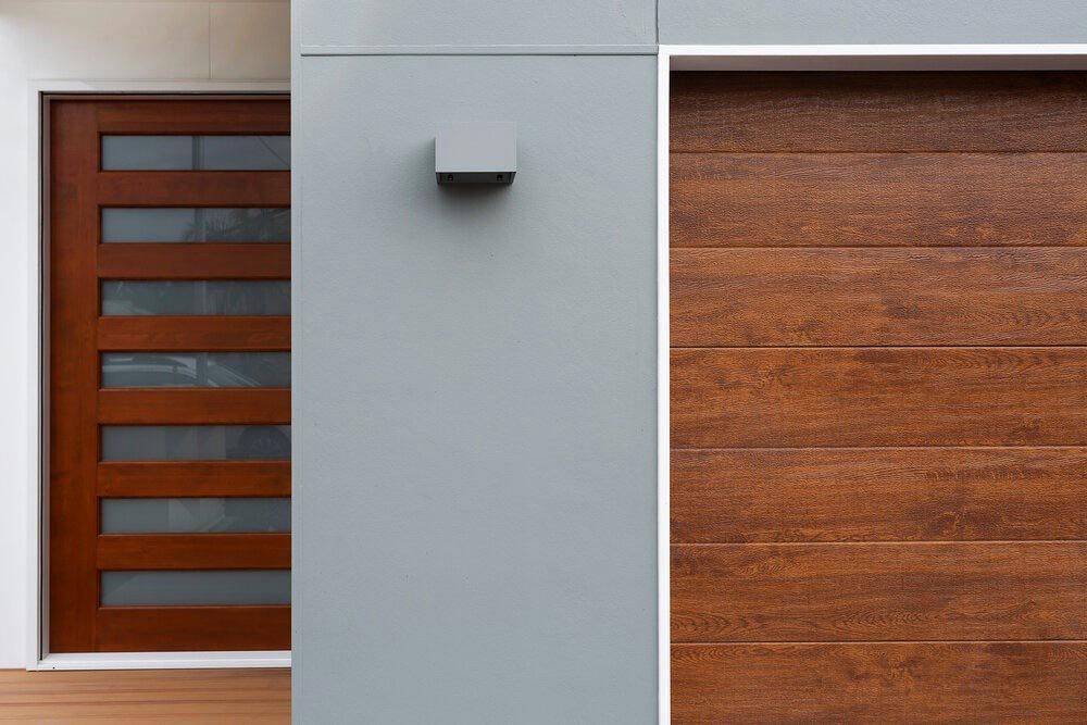 A House With a Wooden Door and a Wooden Garage Door — DeBu Studios In Russell Vale, NSW