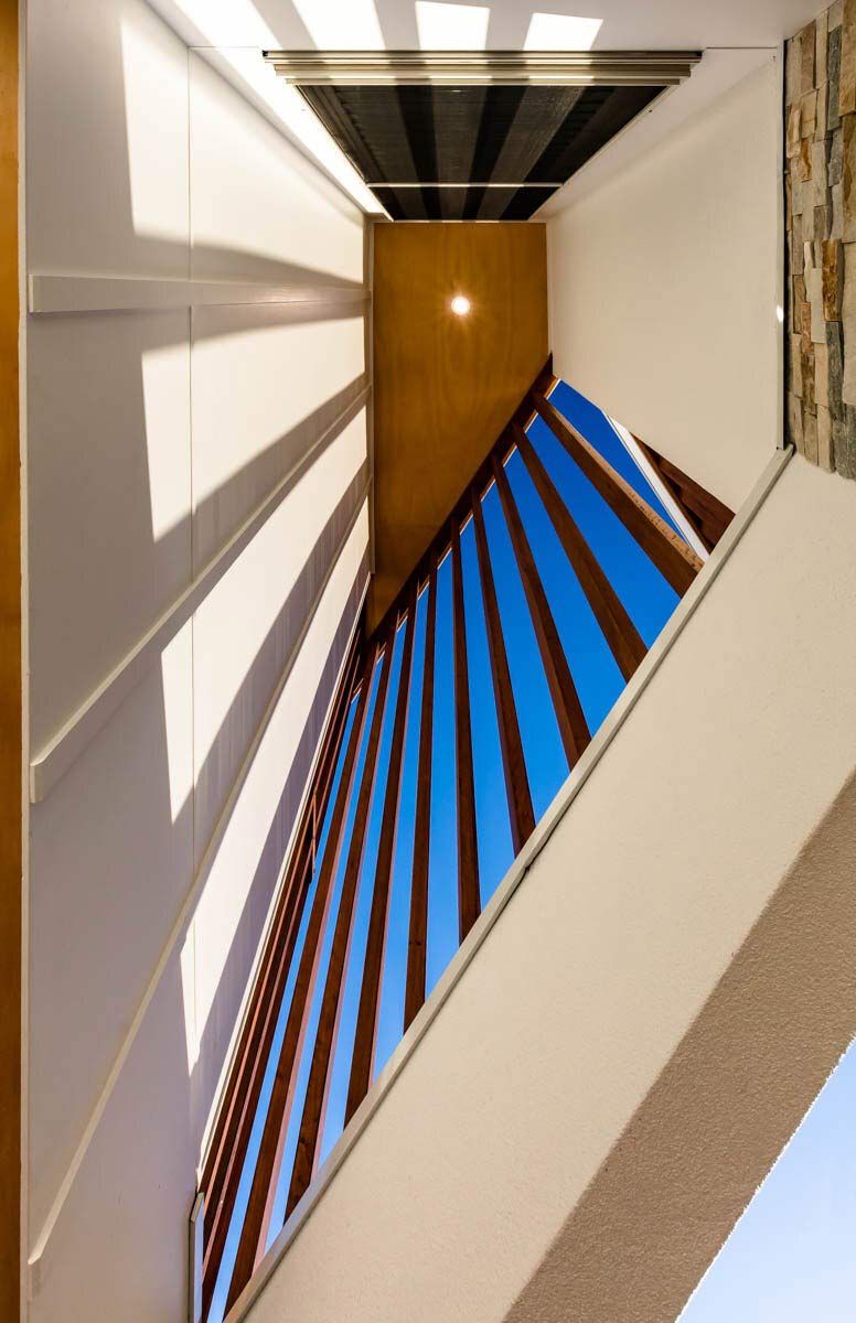 A Staircase With a Blue Railing and a Blue Sky Behind It — DeBu Studios In Russell Vale, NSW