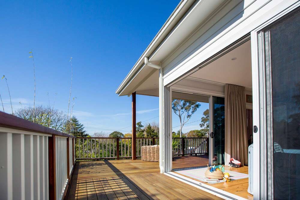 A House With a Large Sliding Glass Door Leading to a Deck — DeBu Studios In Russell Vale, NSW