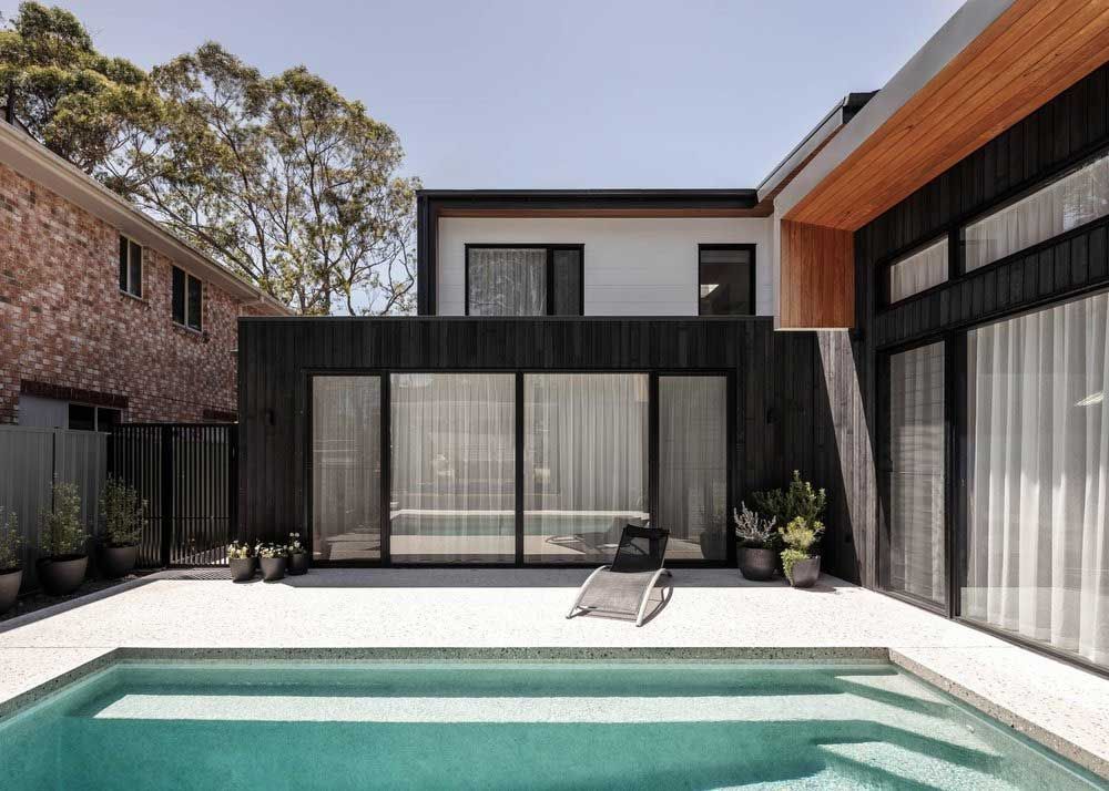A Large House With a Swimming Pool in Front of It — DeBu Studios In Russell Vale, NSW