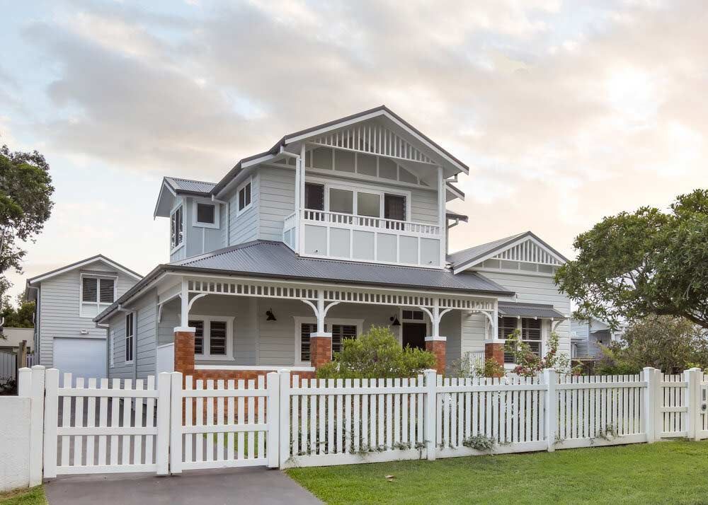 A Large White House With a White Picket Fence Around It — DeBu Studios In Russell Vale, NSW