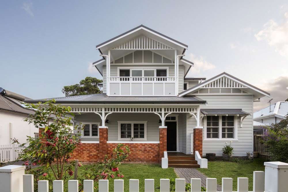 A Large White House With a Fence in Front of It — DeBu Studios In Russell Vale, NSW